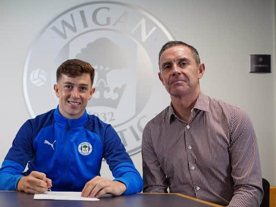Jensen Weir signs for Latics, watched on by dad, David