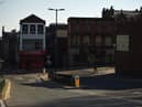 A pedestrian walks in a quiet street in Oldham