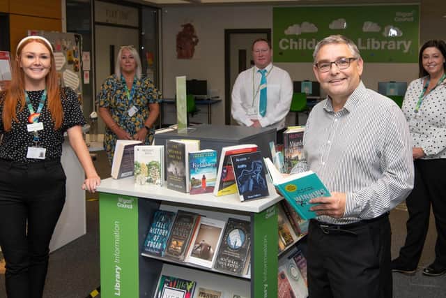 Coun Chris Ready and council staff in Wigan Library