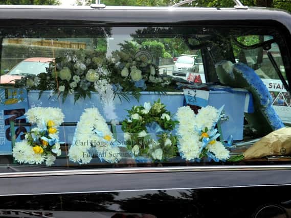 A blue coffin marked Jack's love of Manchester City