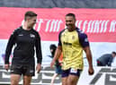 Willie Isa shares a joke with an official before kick-off