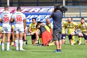 Bevan French and David Fifita took a knee with the Aboriginal Australian flag draped over their backs