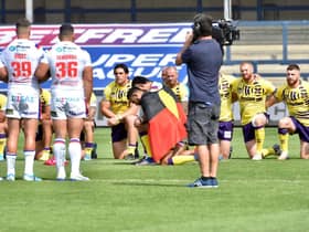 Bevan French and David Fifita took a knee with the Aboriginal Australian flag draped over their backs