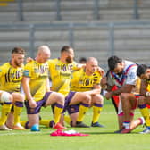 Bevan French and Wakefield's David Fifita take the knee with the Australian Aboriginal flag draped over their backs on Sunday