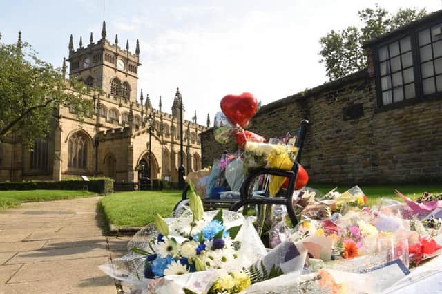 A large number of flowers and other tributes have been left outside Wigan Parish Church in memory of Steven McMyler