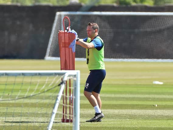 Leam Richardson, Paul Cook's former assistant, wipes down equipment when the squad returned after the lockdown in early summer. He will take charge of training
