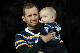 Rob Burrow and child Jackson at a testimonial match at Headingley earlier this year