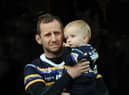 Rob Burrow and child Jackson at a testimonial match at Headingley earlier this year