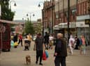 Shoppers make their way through the town centre in Oldham