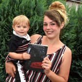 Taylor and son Levi with the book