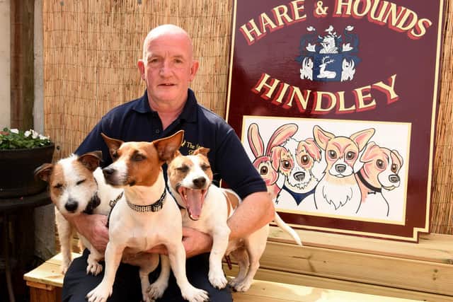 Photo Neil Cross; Pub landlord Dave O'Hara has had a new sign created for the Hare and Hounds pub, featuring his three dogs