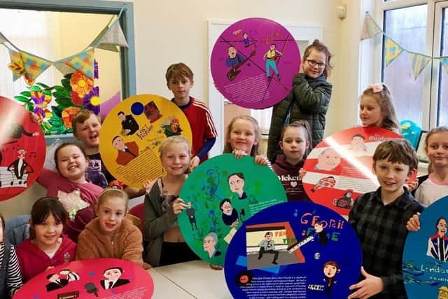 Primary school pupils with the plaques they helped to create