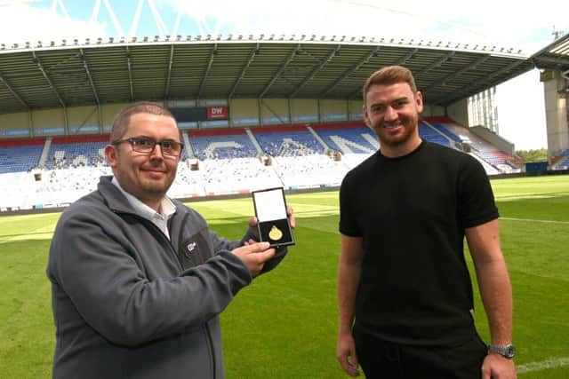 Fan Mark Holdsworth won Jamie Jones' League One medal... and then presented it straight back to the goalkeeper. Picture: Michelle Adamson