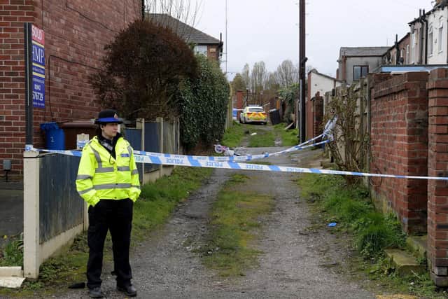 Police seal off the alleyway at the back of the home where Debbie Twist was fatally injured