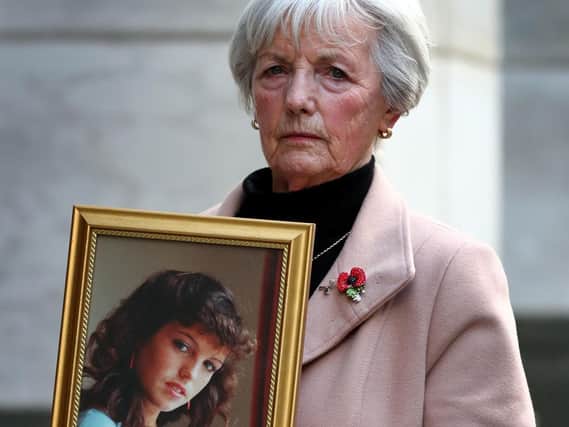Marie McCourt with a picture of daughter Helen