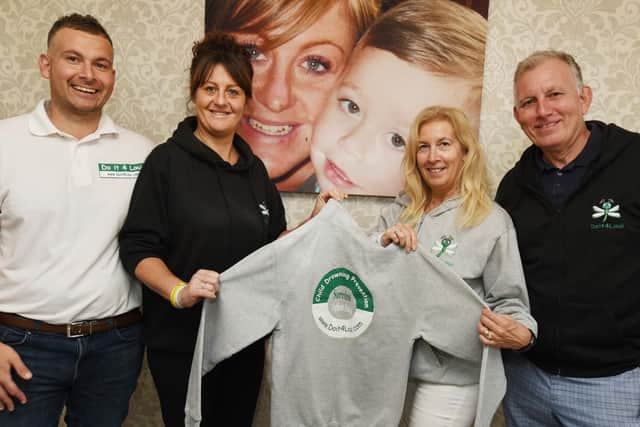 Loui's parents Gavin and Emma Aspinall with his grandparents Anne and Tim Aspinall, next to a photograph of Loui