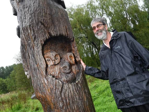 Michael Hurst admires the wood carvings
