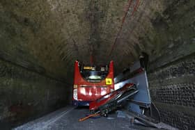 A double-decker school bus crashed into a railway bridge