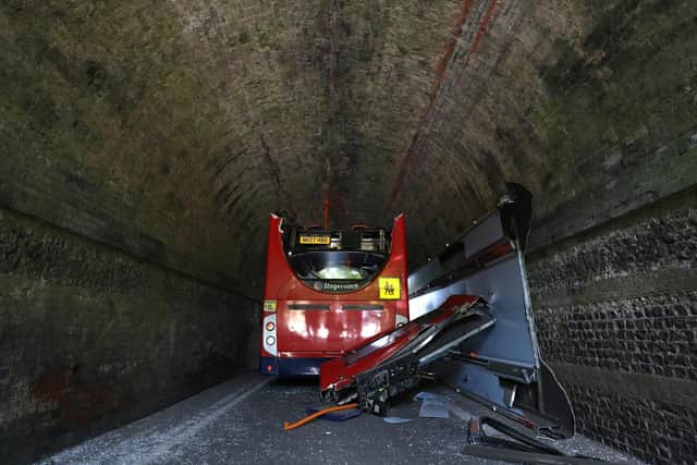 A double-decker school bus crashed into a railway bridge