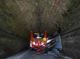 A double-decker school bus crashed into a railway bridge