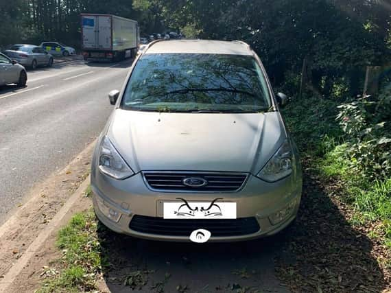 A car ticketed by police on the main road outside Fairy Glen