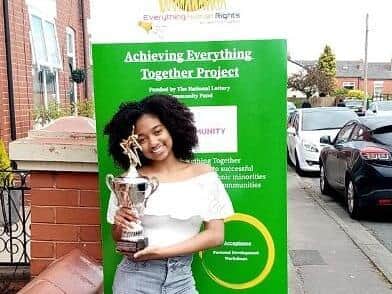 The winner of the Afrobeats dance contest with her trophy