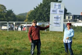 Residents protest as a planners' site visit takes place in the background