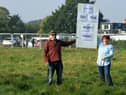 Residents protest as a planners' site visit takes place in the background