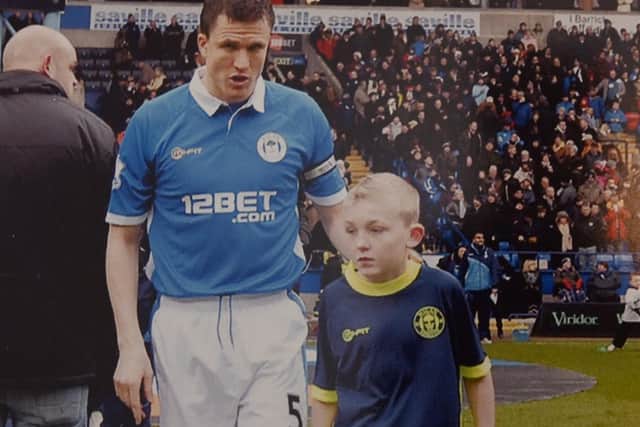 Bradley Foster leads out Latics as mascot