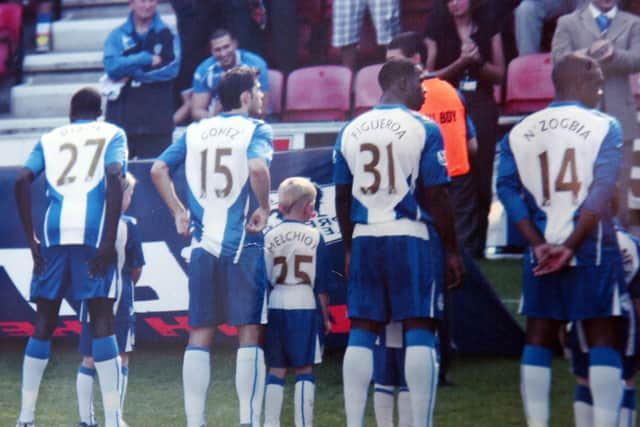 A younger Bradley leads out the Latics team