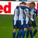 Joe Garner is mobbed after his winning goal