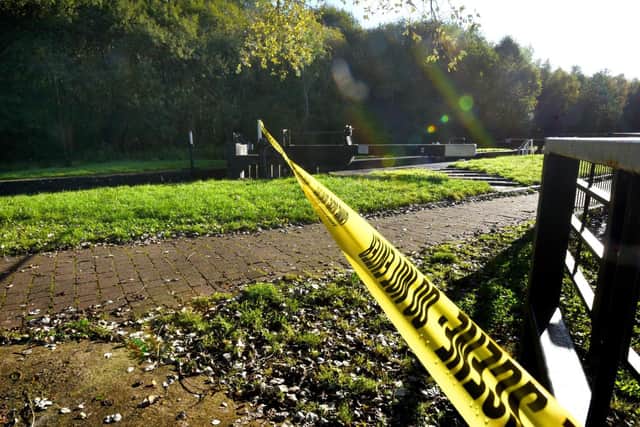 Crime scene tape has been placed across the towpath