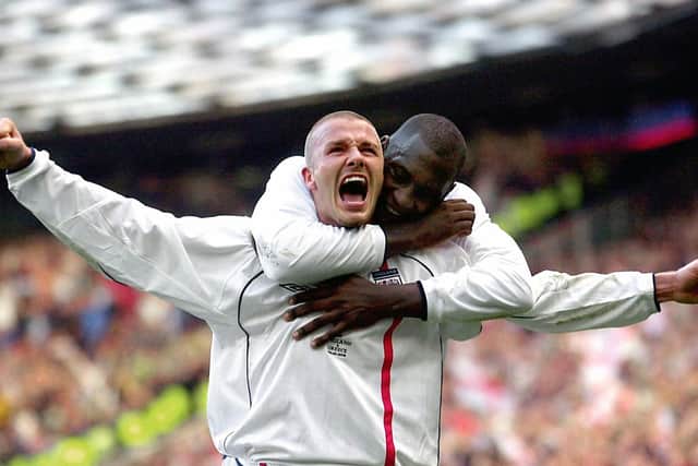 England captain David Beckham celebrates after scoring the equaliser from a free-kick against Greece in the dying seconds of a World Cup qualifier at Old Trafford on October 6, 2001