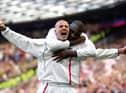 England captain David Beckham celebrates after scoring the equaliser from a free-kick against Greece in the dying seconds of a World Cup qualifier at Old Trafford on October 6, 2001