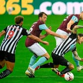 Newcastle United's Irish midfielder Jeff Hendrick is tackled by Burnley's English defender James Tarkowski (back) and Dale Stephens (2nd L) during the English Premier League football match between Newcastle United and Burnley at St James' Park in Newcastle-upon-Tyne, north east England on October 3, 2020. (Photo by PETER POWELL / POOL / AFP)