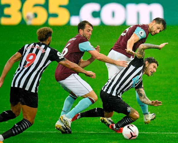 Newcastle United's Irish midfielder Jeff Hendrick is tackled by Burnley's English defender James Tarkowski (back) and Dale Stephens (2nd L) during the English Premier League football match between Newcastle United and Burnley at St James' Park in Newcastle-upon-Tyne, north east England on October 3, 2020. (Photo by PETER POWELL / POOL / AFP)