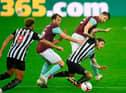 Newcastle United's Irish midfielder Jeff Hendrick is tackled by Burnley's English defender James Tarkowski (back) and Dale Stephens (2nd L) during the English Premier League football match between Newcastle United and Burnley at St James' Park in Newcastle-upon-Tyne, north east England on October 3, 2020. (Photo by PETER POWELL / POOL / AFP)
