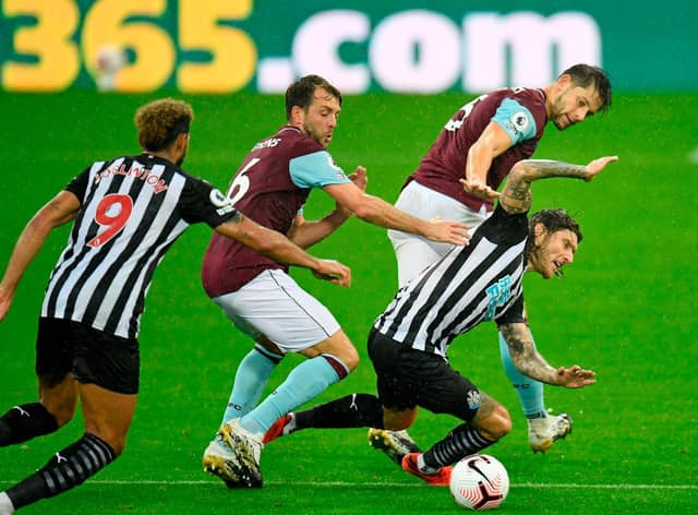 Newcastle United's Irish midfielder Jeff Hendrick is tackled by Burnley's English defender James Tarkowski (back) and Dale Stephens (2nd L) during the English Premier League football match between Newcastle United and Burnley at St James' Park in Newcastle-upon-Tyne, north east England on October 3, 2020. (Photo by PETER POWELL / POOL / AFP)