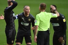 The Latics players remonstrate with referee Ollie Yates, to no avail