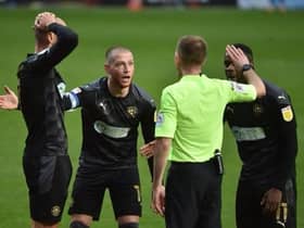 The Latics players remonstrate with referee Ollie Yates, to no avail