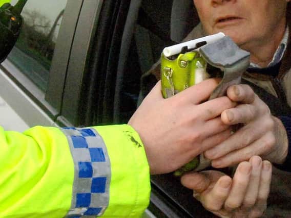 A motorist being given a breath test by a police officer