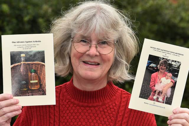 Sarah with the booklets she has produced