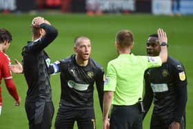 Some of the Latics players surround referee Ollie Yates at Charlton
