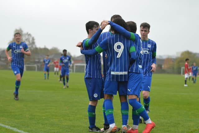 The Latics youngsters celebrate one of the goals that saw off Manchester United
