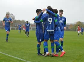 The Latics youngsters celebrate one of the goals that saw off Manchester United