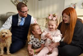 Seven-year-old Hallie Campbell with stepdad Barry Gumbley, sister Macy, 10, and mum Lucy Campbell