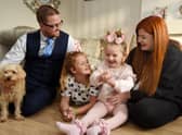 Seven-year-old Hallie Campbell with stepdad Barry Gumbley, sister Macy, 10, and mum Lucy Campbell