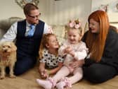 Seven-year-old Hallie Campbell with stepdad Barry Gumbley, sister Macy, 10, and mum Lucy Campbell