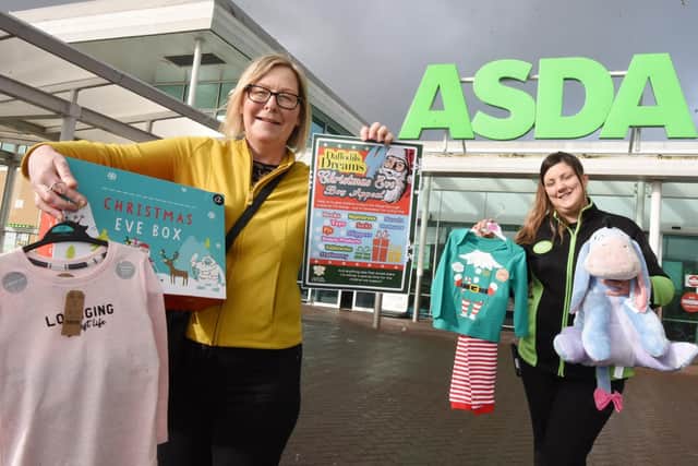 Maureen Holcroft, from Daffodils Dreams, launches the Christmas Eve box campaign with Charlene Frodsham, community champion at Asda in Newtown