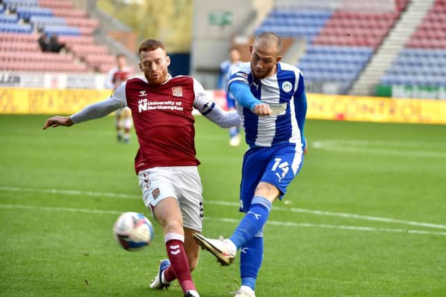 Joe Garner gets a shot away against Northampton